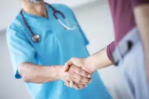 Contact Page Doctor shakes hands with a patient