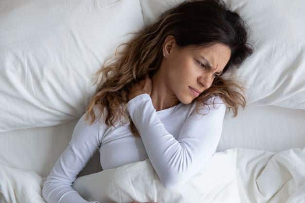 woman neck pain trouble sleeping