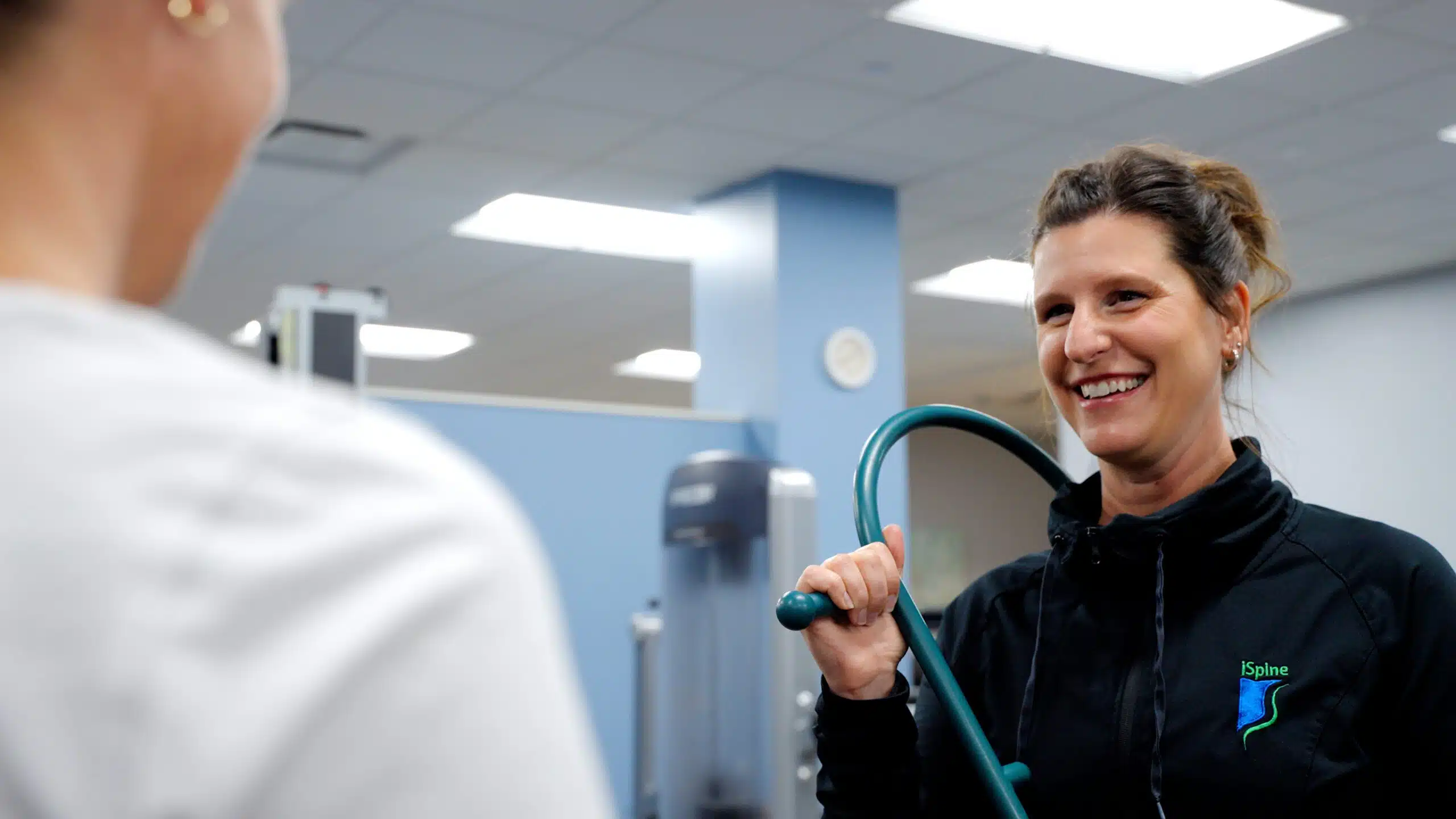 iSpine Rehab therapist with patient iSpine Rehab therapist with patient using trigger point massage tool