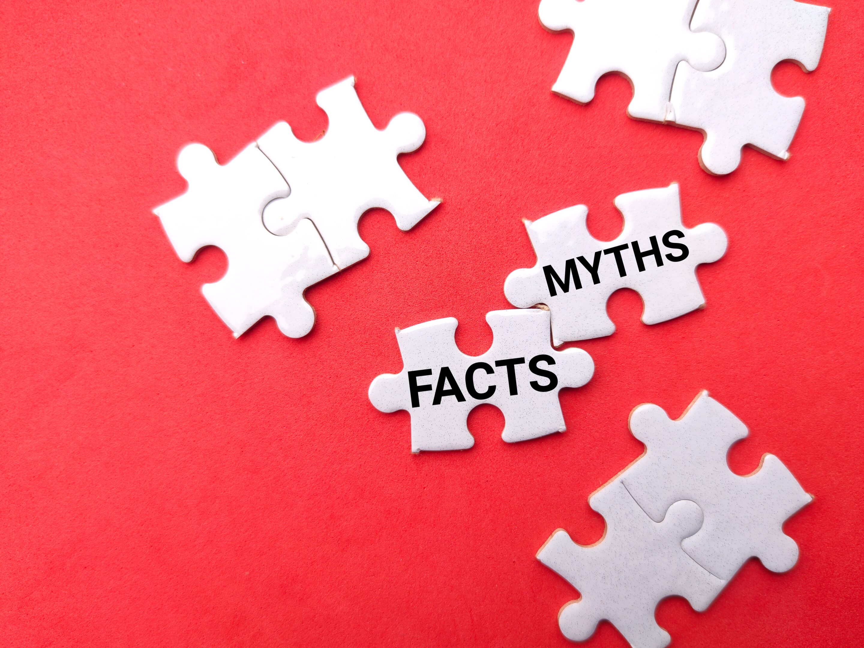 White,Puzzle,With,Text,Facts,Myths,On,A,Red,Background.