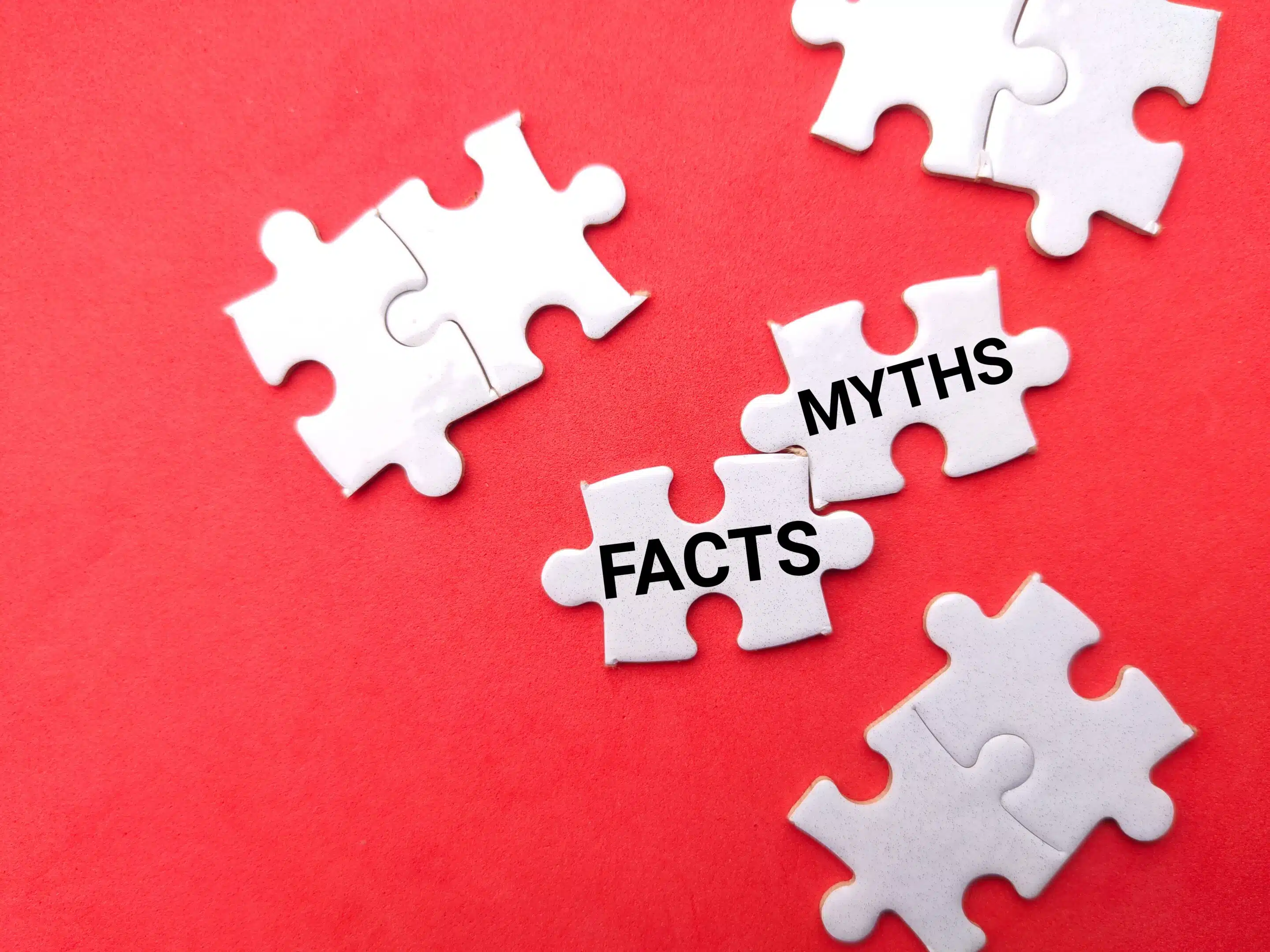 White,Puzzle,With,Text,Facts,Myths,On,A,Red,Background.