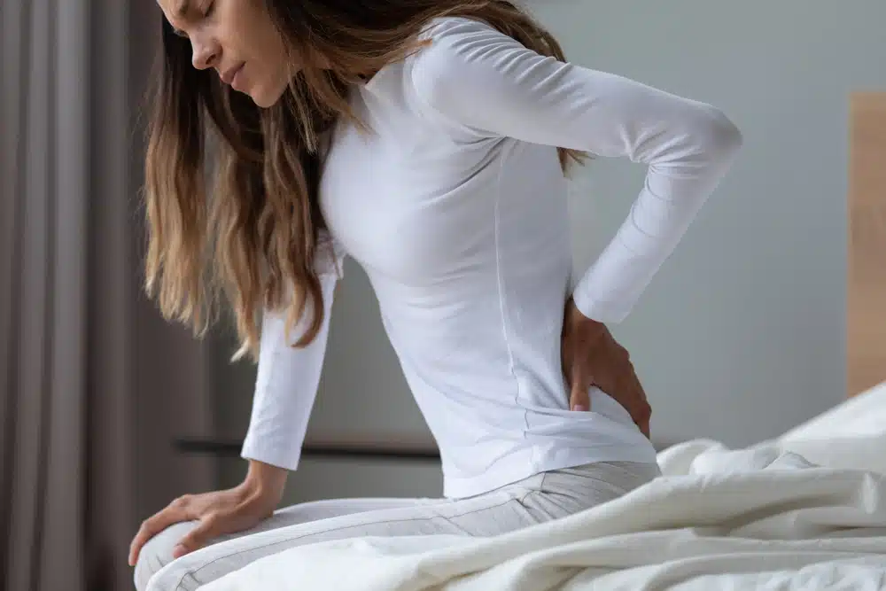 Close,Up,Unhappy,Woman,Wearing,Pajama,Rubbing,Stiff,Back,Muscles Lower back pain is one of the most common medical complaints, and it’s the leading cause of disability worldwide.