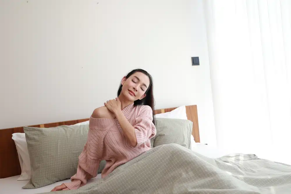 Serene,Morning,As,Woman,Gently,Stretches,Neck,In,Bed,,Eyes Woman stretching neck in bed